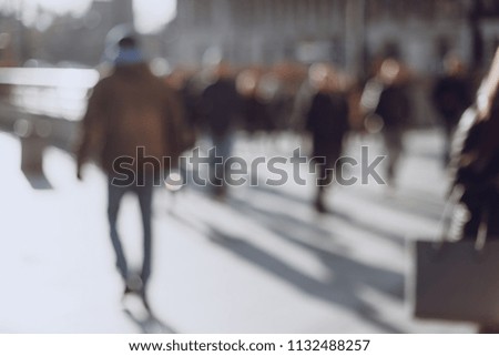 Blurred background made of people walking through the city
