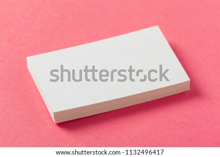 Blank paper pieces  on a colored pink background