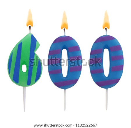 Burning birthday candles isolated on white background, number 600