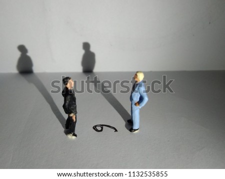 illustration,  different perspective makes another value,  standing businessman mini figure toys facing number six or nine Royalty-Free Stock Photo #1132535855