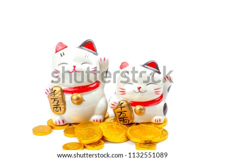 Lucky cat statue for Japanese isolated on a white background, Holds a gold medal in Japanese that translates into prosperity and good fortune.