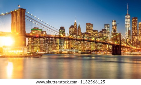a magnificent view of the lower Manhattan and Brooklyn Bridge with sunset