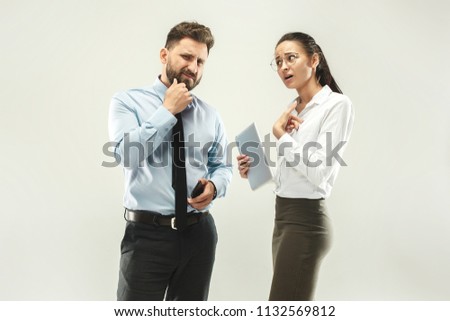 Angry boss. Man and his secretary standing at office or studio. Business man pointing to camera with his colleague. Female and male caucasian models. Office relationships concept, Human emotions