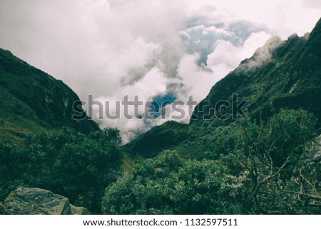 The green wild forest of the andes and impressive clouds formation on the background. Peru. South America. No people.