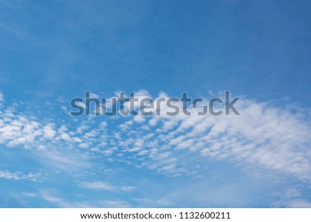 Texture of clouds on blue sky illuminated by sunlight