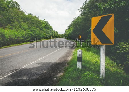 Curved road,trees and grass on roadside. landscape with sky and sun.