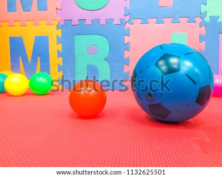Many coloured plastic balls Red background