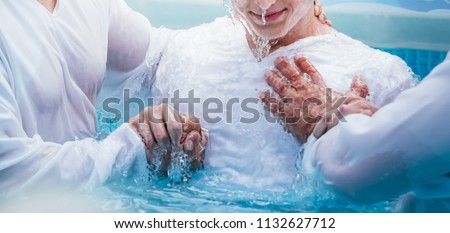 Two pastors baptize man Royalty-Free Stock Photo #1132627712
