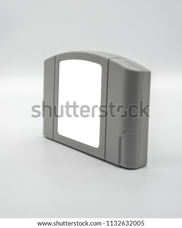 TV game cartridge in grey plastic case from 90s isolated on white background