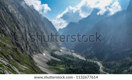 Mountains range and high valley in the Alps.
