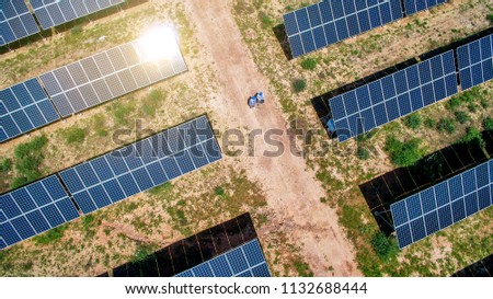 Overshooting engineer who is inspecting solar photovoltaic area