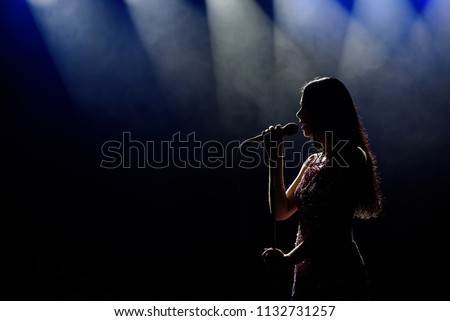 Singer woman on stage Royalty-Free Stock Photo #1132731257