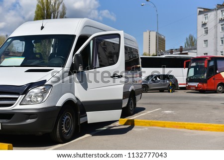 white microbus on bus station Royalty-Free Stock Photo #1132777043