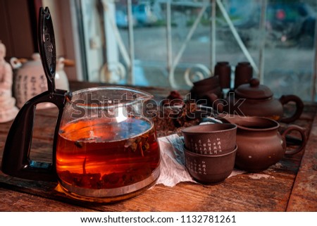 modern glass kettle with brewing on an old wooden table