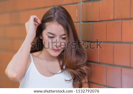 Portrait of beautiful asian chic girl wear black dress pose for take a picture on brick wall,Lifestyle of teen thailand people,Modern woman happy concept