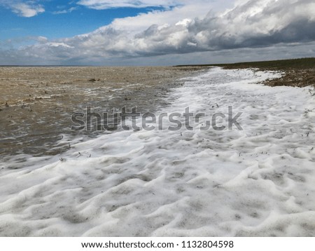 cheerful tide of the sea against the sky and white clouds