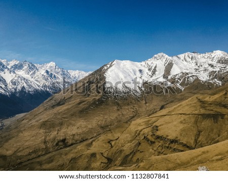 landscape of mountains and hills covered with snow against the sky