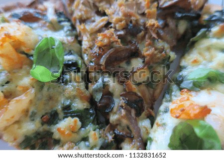                                Three pizza slices with sea food, basil, shrimp, mushroom and cheese