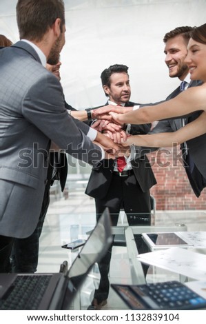 Business Team putting their hands together