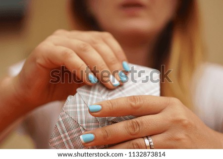Female hold few playing cards with cover 