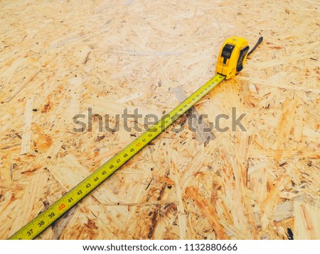 Measuring device for construction. The concept for builders. Yellow Roulette.