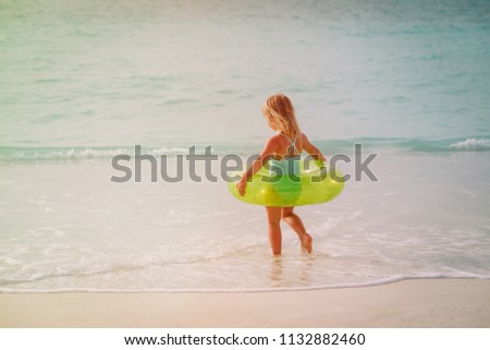 little girl go swim on beach