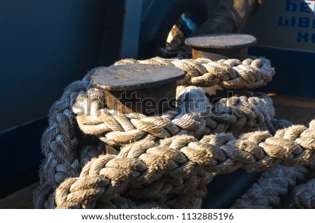 Old braided rope on the wooden deck of a sea boat
