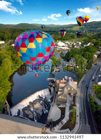 Floating above the ground through a hot air balloon festival. Royalty-Free Stock Photo #1132941497