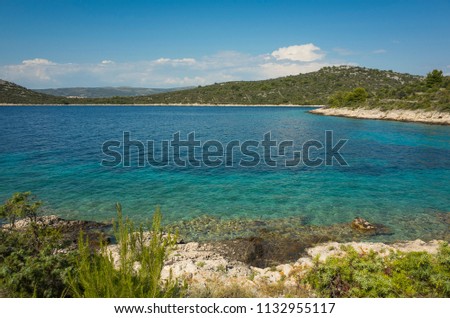 Beautiful nature and landscape photo of sunny summer day at Adriatic Sea in Dalmatia, Croatia, Europe. Nice outdoors at Mediterranean coast. Calm, peaceful and happy picture.