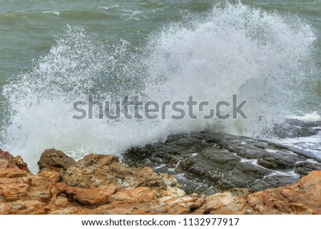Sea waves hit the wind when it hits the rock, causing the sea to split into a beautiful picture.
