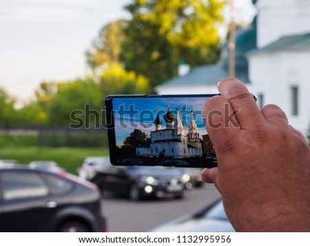 A man is taking pictures of a church in Yaroslavl