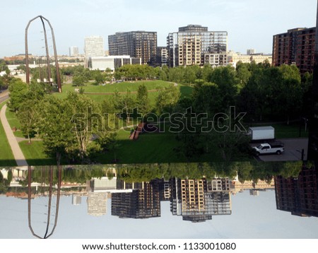 Minneapolis urban landscape with Gold Medal park in the foreground. Modern art objects. Reflection.
