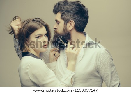 Beard makes your appearance more masculine and brutal. Beard care tricks keep facial hair look resplendent. Masculinity concept. Girl barber with scissors cutting beard hair brutal bearded hipster.