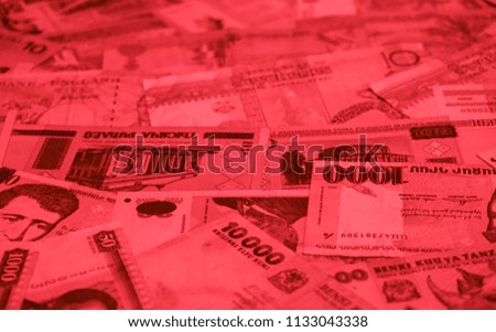 Red bloody colored money of different countries. Coins and banknotes. Currencies