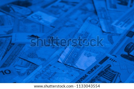 Blue colored money of different countries. Coins and banknotes. Currencies