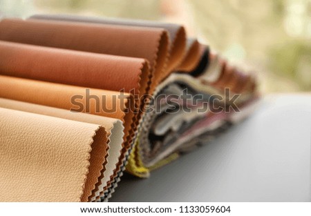 Leather samples of different colors for interior design on table