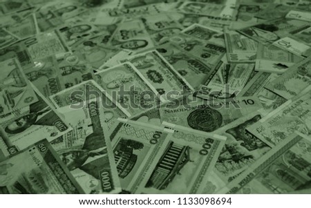 Salad colored money of different countries. Coins and banknotes. Currencies
