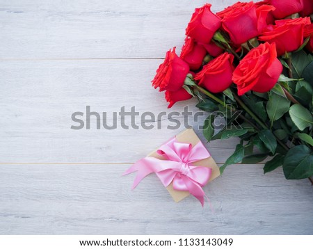 red roses on a wooden background, for postcards, greetings, space for text