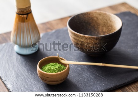 green matcha tea prepearing on stone black table 