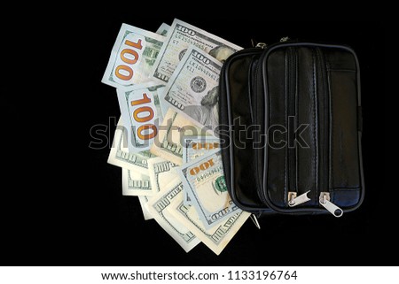 a lot of money in the hand bag 100 dollars,