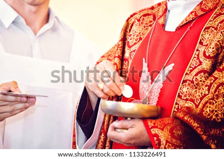 Catholic priest giving Holy Communion