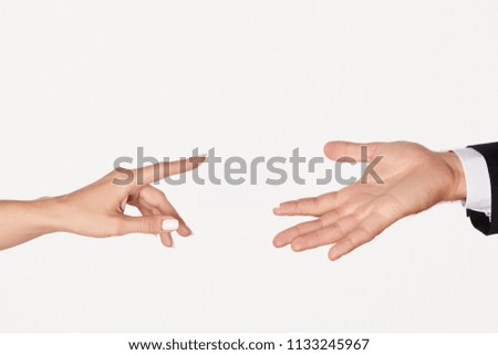 partial view of businesswoman giving visit card to businessman isolated on white background
