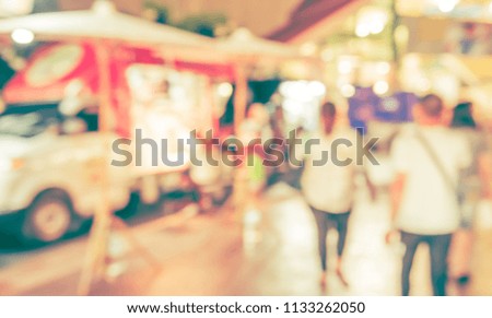 Abstract blur image of  People at Street night  market with bokeh for background usage . (vintage tone)