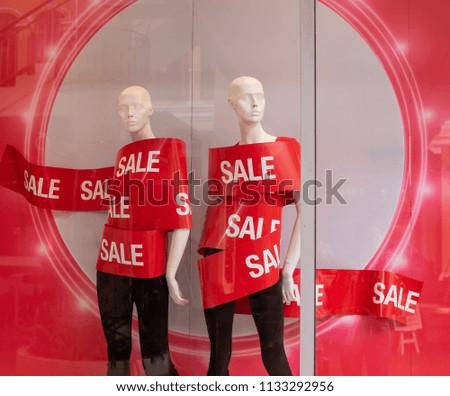 In Selective Focus of Red text SALE  Wrapping on Mannequin in Showroom at Summer Fast Discounts Zone in the Department Store Background. 