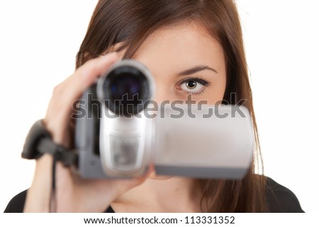 young woman with camera taking movie, white background