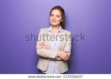Young woman in formal clothes on color background