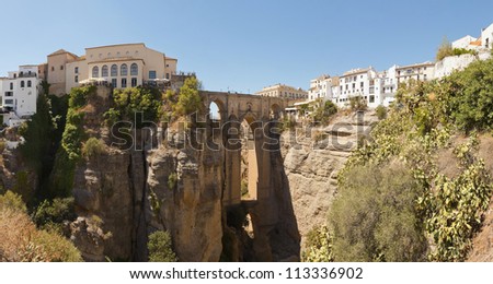 Panoramic photo of the famous bridge over the canyon of the Guadalevin river in Ronda. Puente Nuevo. Malaga. Andalusia. Spain.