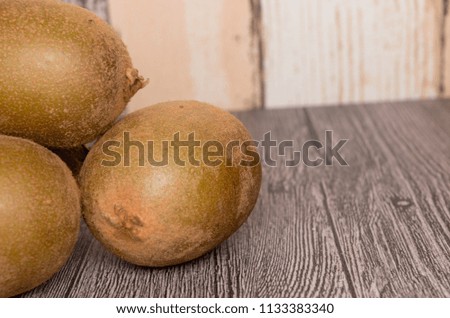 The kiwi fruit on the wooden background. Selective focus.