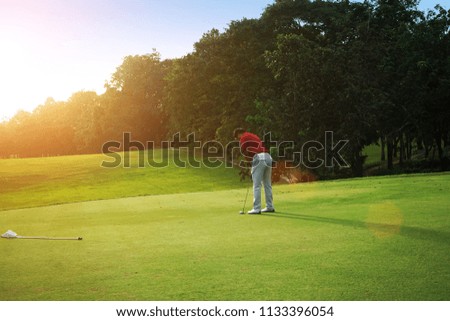 Blurred Golfers are putting golf in the evening golf course golf backglound in Thailand