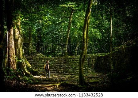 Adventure travel in jungle ruins with woman traveller Royalty-Free Stock Photo #1133432528